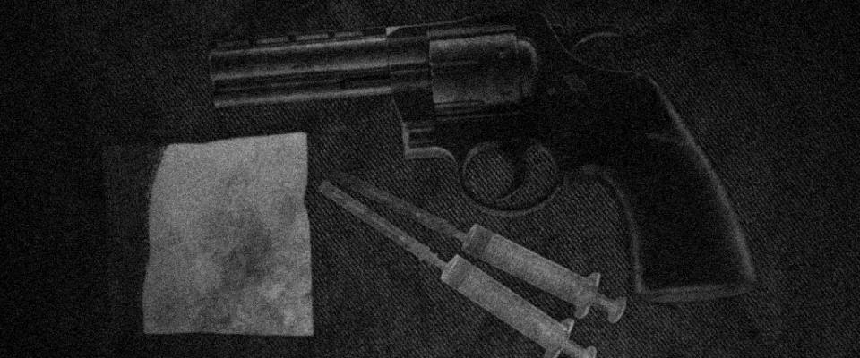 A revolver and pitchfork drug paraphernalia.