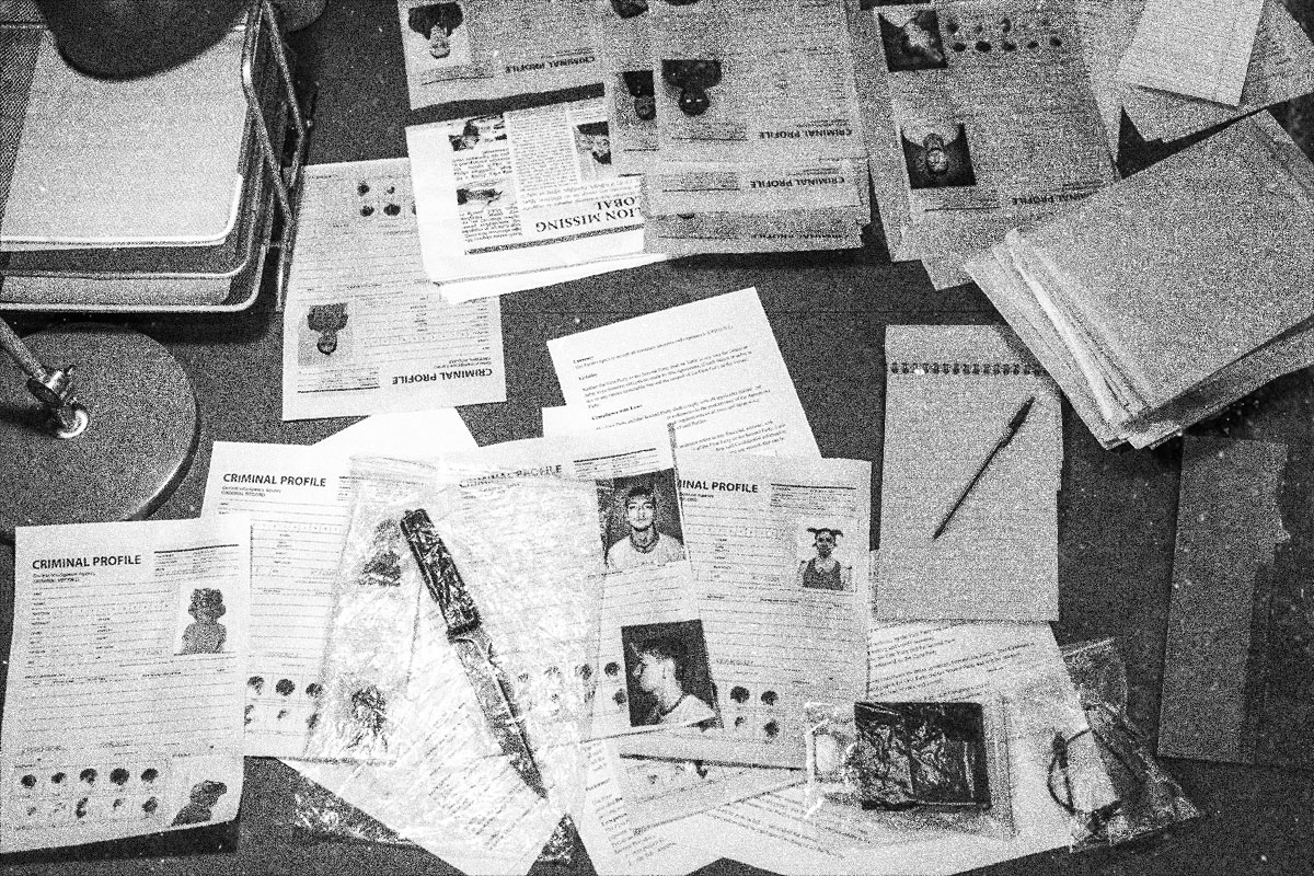 Criminal Profiles scattered across a desk