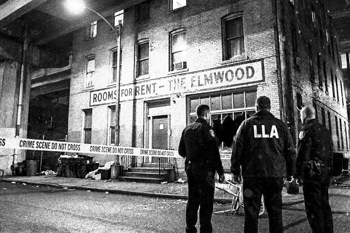 Three officers standing outside of a boarding house in Wilcox